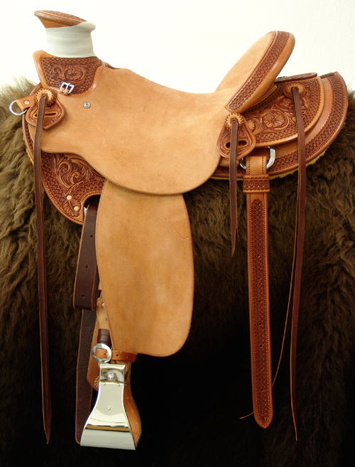 8 & 1/2 Half Breed Wade Saddle by Keith Valley   Specs: Wade tree by Rick Reed 16 inch seat Gullet - 7 & 1/2H by 6 & 1/4W by 4 94 Degree Bars Horn - 3 & 5/8ths high by 4 & 1/2 Guatelajara Cantle - 4&1/2 inches high by 12&1/2 inches wide Cheyenne Roll - 1 & 3/4 inches 7/8ths flat plate riggin Vaquero Geometric Border with Sheridan Style Floral Stainless Steel Hardware - by Harwood 4&1/2 inch Monel Stirrups Santa Barbara twisted stirrup leathers Full length stirrup leathers 32 inch 100% Mohair Roper Cinch 7 foot latigos - both sides Ready to ride and go to work.